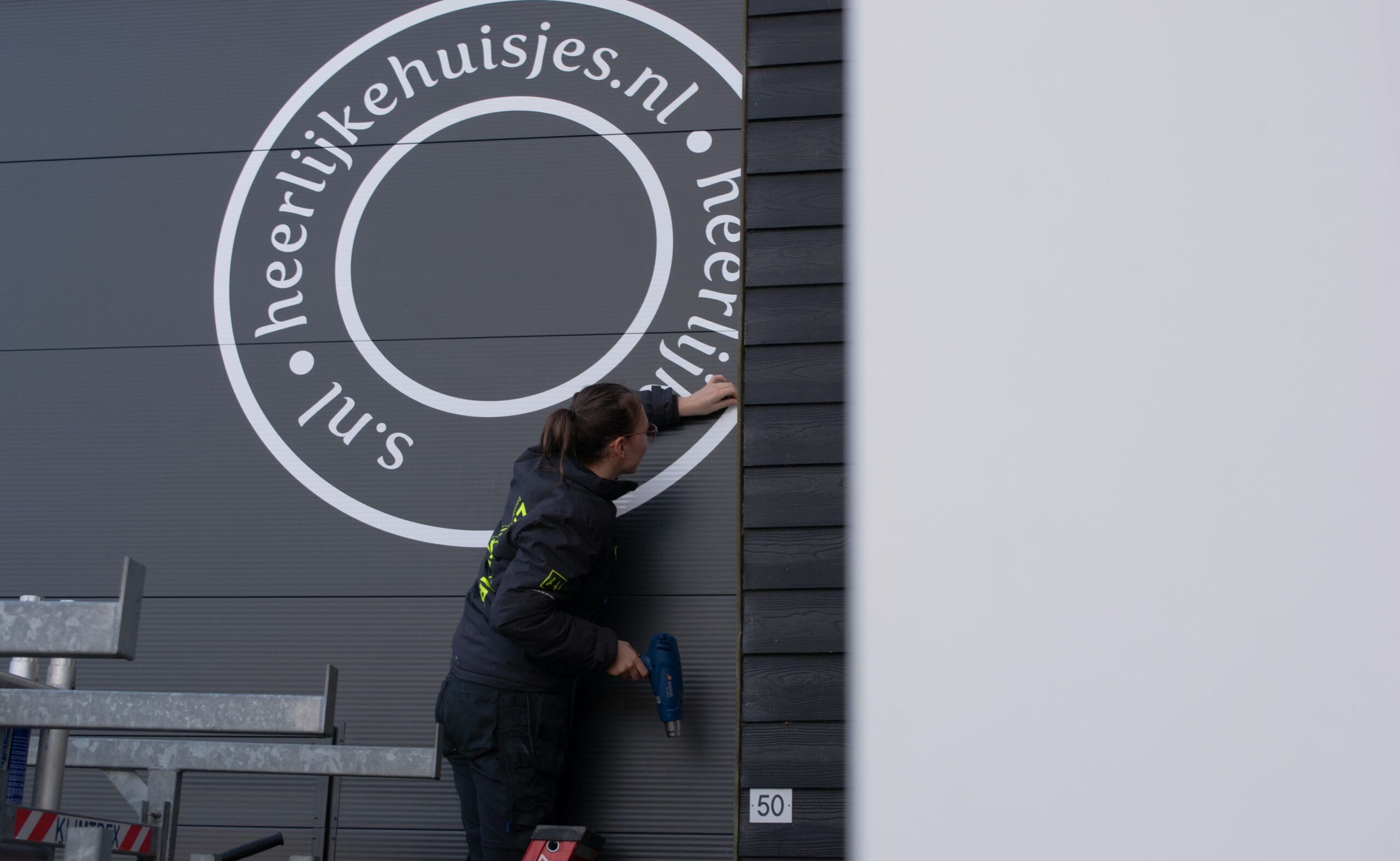 gevelbestickering gemonterd op zwarte gevel